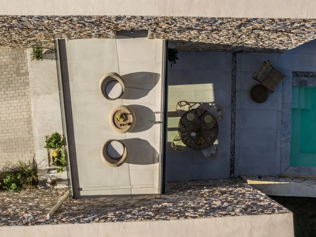 Top-down view of a villa terrace and private pool at Norte Luxury Villas