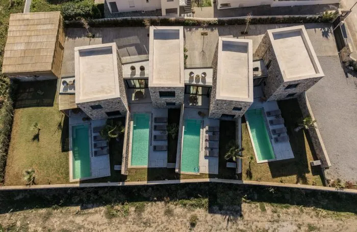 Aerial view of the four stone villas with private pools at Norte Luxury Villas, Evia